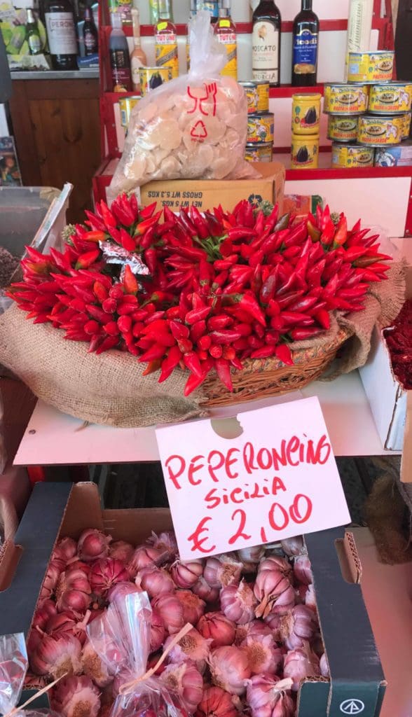 peperoncino and garlic in a local Italian market display, slow travel slow tourism allows cultural appreciation